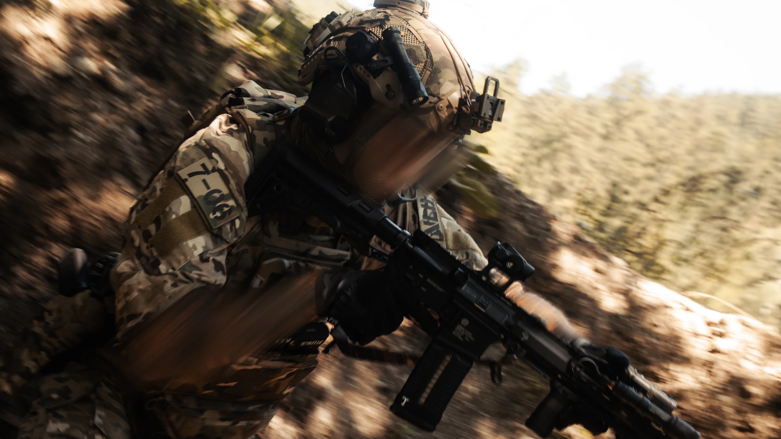 Operator in multicam gear advancing with rifle raised, motion blur