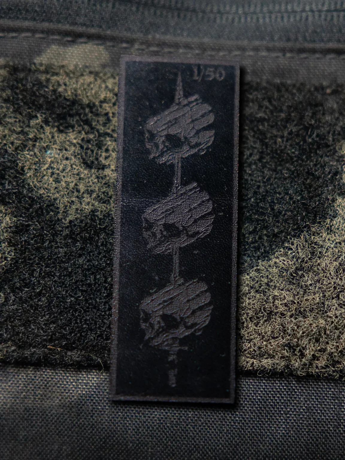 Tier 1 Controlled Chaos Patch in numbered black on black, leather patch close-up by The Trace