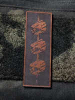 Tier 1 Controlled Chaos Patch in brown on black, leather patch close-up by The Trace