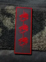Tier 1 Controlled Chaos Patch in red on black, leather patch close-up by The Trace