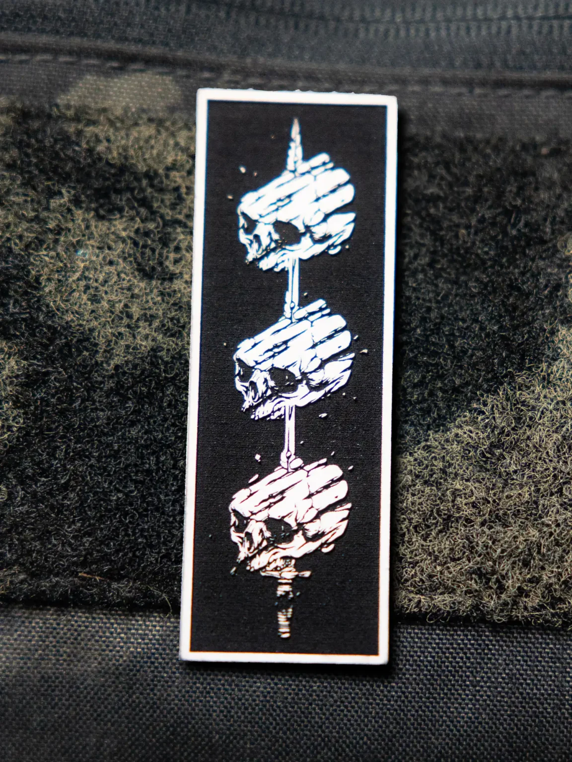 Tier 1 Controlled Chaos Patch in white on black, leather patch close-up by The Trace